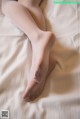 A close up of a woman's legs on a bed.