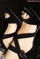 A close up of a woman's feet wearing black sandals.