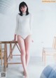 A woman in a white sweater and white panties posing for a magazine.