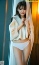 A woman in a white fur coat posing for a picture.